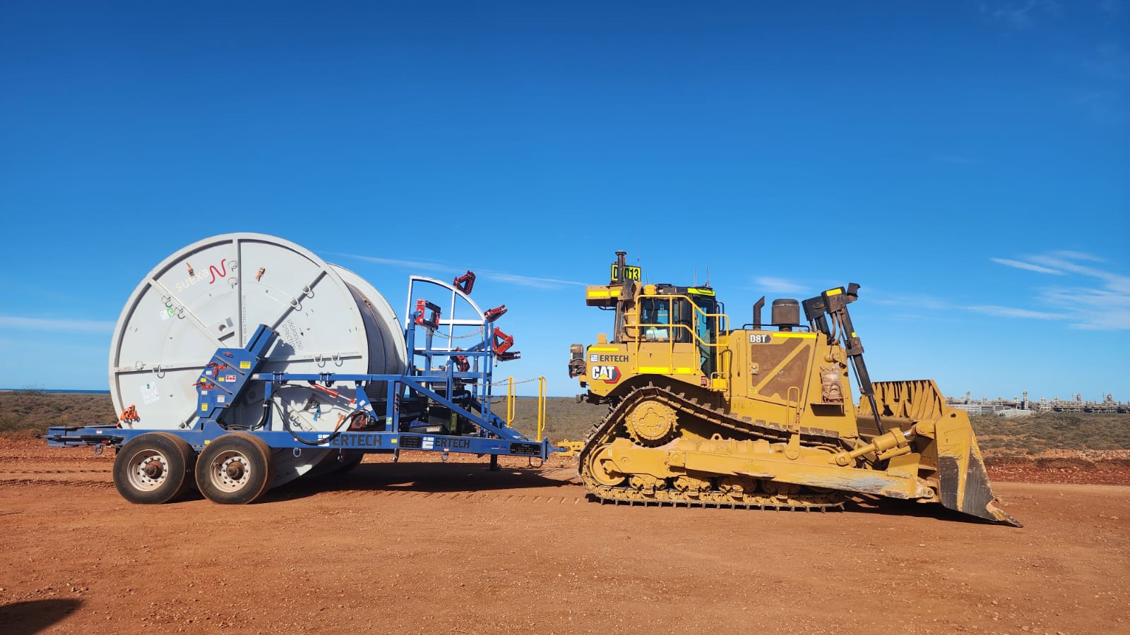 Titan Series cable trailer in the field with jinker — active cable deployment on rugged terrain