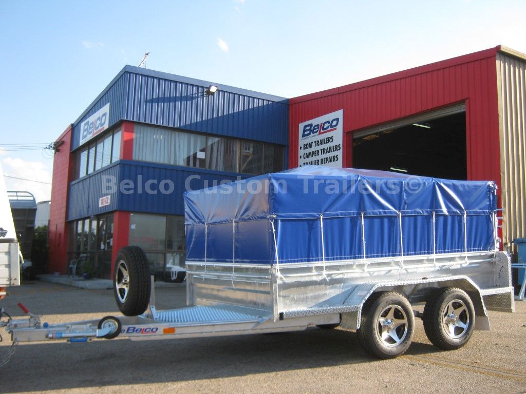 Custom-built flatbed trailer with front and rear loading ramps